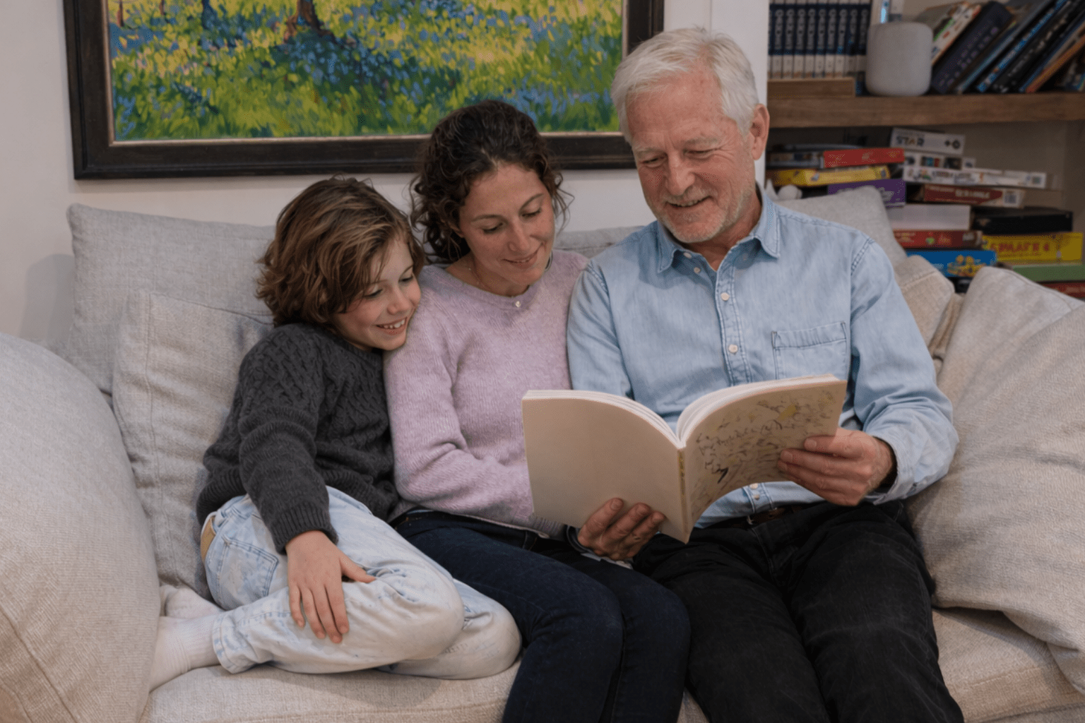 man sharing life story book with family that he created while taking a memoir writing course online